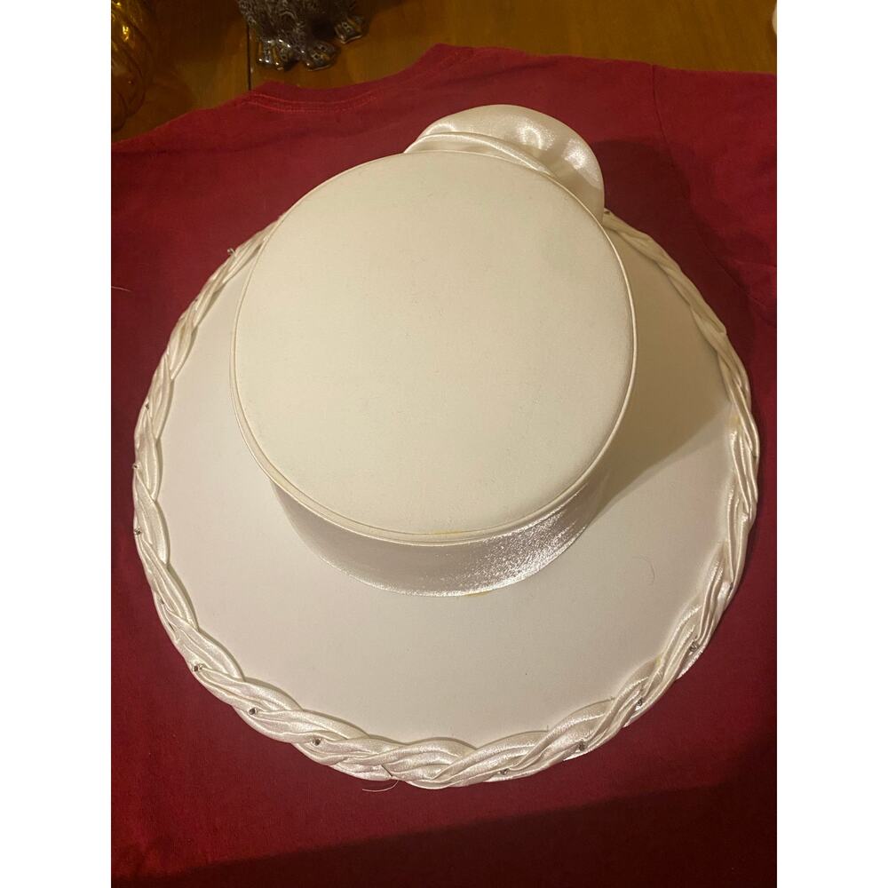 White satin pillbox hat with decorative bow detail